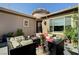 Charming back patio featuring comfortable seating around a fire pit, with potted plants and garden views at 8564 Mayport Dr, Las Vegas, NV 89131