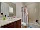 Cozy bathroom featuring a single sink vanity with neutral tile and a shower-tub combination at 8564 Mayport Dr, Las Vegas, NV 89131