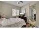 Comfortable bedroom with wood floors, window with plantation shutters, and an adjacent bathroom at 8564 Mayport Dr, Las Vegas, NV 89131