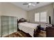 Cozy bedroom featuring a ceiling fan, wood floors, and plantation shutters for a warm and inviting space at 8564 Mayport Dr, Las Vegas, NV 89131