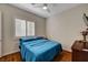 A cozy bedroom with minimalist décor features a window with shutters for privacy and natural light at 8564 Mayport Dr, Las Vegas, NV 89131