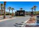 A modern gatehouse with stone accents and mature palm trees welcomes residents to this luxurious community at 8564 Mayport Dr, Las Vegas, NV 89131