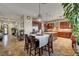 Open-concept kitchen flows into the dining area with granite countertops and custom cabinets at 8564 Mayport Dr, Las Vegas, NV 89131