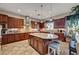 Spacious kitchen features an island with granite countertops, stainless steel appliances, and custom cabinets at 8564 Mayport Dr, Las Vegas, NV 89131