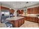 Gourmet kitchen with granite island, stainless steel appliances, and custom cabinets at 8564 Mayport Dr, Las Vegas, NV 89131