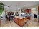 Open concept kitchen with granite island, modern appliances, and seamless flow to dining and living areas at 8564 Mayport Dr, Las Vegas, NV 89131