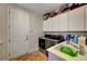 A well-equipped laundry room offers modern appliances, counter space, and storage cabinets for convenience at 8564 Mayport Dr, Las Vegas, NV 89131