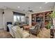 A cozy living area features neutral tones, a ceiling fan, and a large window at 8564 Mayport Dr, Las Vegas, NV 89131