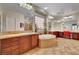 A luxurious bathroom boasts dual vanities, a garden tub, and tiled floors at 8564 Mayport Dr, Las Vegas, NV 89131