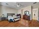 A bright main bedroom features hardwood floors, a ceiling fan, and closet access at 8564 Mayport Dr, Las Vegas, NV 89131