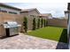 Paver patio, artificial grass, and stainless grill make this a perfect backyard for relaxation and entertainment at 862 Silverton Springs St, Henderson, NV 89011