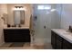 Bright bathroom with walk-in shower, dark cabinets and double-sink vanity at 862 Silverton Springs St, Henderson, NV 89011