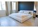 Modern bedroom with minimalist design, light wood floors and bright windows at 862 Silverton Springs St, Henderson, NV 89011