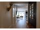 Inviting home hallway featuring wood-look flooring, a bench, dark accent wall, and views into the dining and kitchen at 862 Silverton Springs St, Henderson, NV 89011