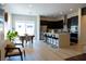 Bright, open kitchen with island seating, modern appliances, dark cabinets, and sliding door to the backyard at 862 Silverton Springs St, Henderson, NV 89011