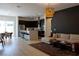 Open-concept living room with dark kitchen cabinets, stainless appliances, an island, and a comfortable sectional sofa at 862 Silverton Springs St, Henderson, NV 89011