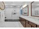Bright bathroom featuring a glass shower, dual sinks and marble counters and floors at 9 Porto Malaga St, Henderson, NV 89011