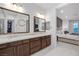 Stylish bathroom featuring dual sinks, a walk-in closet, and a connecting bedroom at 9 Porto Malaga St, Henderson, NV 89011