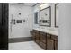 Luxurious bathroom features dual vanities, marble finishes, and a spacious walk-in shower at 9 Porto Malaga St, Henderson, NV 89011