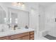 Comfortable bathroom featuring dual sinks, a glass shower, and a marble sink at 9 Porto Malaga St, Henderson, NV 89011