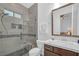 Comfortable bathroom showcasing a glass shower with grey tiled walls, a toilet and a sink at 9 Porto Malaga St, Henderson, NV 89011