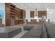 Bright, open kitchen with a large island, custom cabinets, and stainless steel appliances that flows into the living area at 9 Porto Malaga St, Henderson, NV 89011