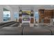Comfortable living room with contemporary furniture, a sleek fireplace, and integrated wine storage solutions at 9 Porto Malaga St, Henderson, NV 89011