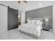 Serene main bedroom with a sliding barn door to the bathroom, soft lighting, and modern finishes at 9 Porto Malaga St, Henderson, NV 89011