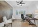 Well-lit office space with a large landscape print, shutters, and an ergonomic chair at 9 Porto Malaga St, Henderson, NV 89011