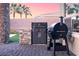 Outdoor kitchen area with a built-in grill, countertop, and adjacent grass at 9 Porto Malaga St, Henderson, NV 89011