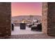 Back patio with brick columns, outdoor seating, and a fire pit, perfect for entertaining at 9 Porto Malaga St, Henderson, NV 89011