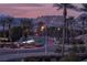 Scenic street view showcasing lush landscaping and swaying palms beneath a beautiful twilight sky at 9 Porto Malaga St, Henderson, NV 89011