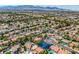 Expansive aerial view of a residential neighborhood with homes, pools, and lush greenery at 9021 Feather River Ct, Las Vegas, NV 89117