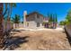 Spacious backyard with dirt landscaping, covered patio, and tall perimeter fence at 9021 Feather River Ct, Las Vegas, NV 89117