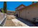 Backyard with dirt landscaping, concrete walkway and block wall fence offers potential for customization at 9021 Feather River Ct, Las Vegas, NV 89117