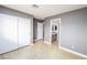 Light and airy bedroom with gray walls, wood-look flooring, and closet space at 9021 Feather River Ct, Las Vegas, NV 89117