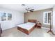 Bedroom with ceiling fan, wood look floors, and windows with shutter coverings at 9021 Feather River Ct, Las Vegas, NV 89117
