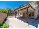 Covered patio with dining set and concrete flooring. Overlooks backyard with block wall fence at 9021 Feather River Ct, Las Vegas, NV 89117