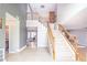 Spacious entryway with tile flooring, staircase, and views into other rooms of the home at 9021 Feather River Ct, Las Vegas, NV 89117