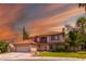 Elegant two-story home with a tile roof, lush landscaping, and inviting curb appeal at 9021 Feather River Ct, Las Vegas, NV 89117