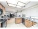 Bright kitchen features tile floors, granite countertops, wood cabinets, and stainless steel sink at 9021 Feather River Ct, Las Vegas, NV 89117