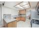 Well-lit kitchen with granite countertops, wooden cabinets, and stainless steel appliances at 9021 Feather River Ct, Las Vegas, NV 89117