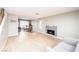 Open-concept living room with fireplace, wood floors, and access to dining area at 9021 Feather River Ct, Las Vegas, NV 89117