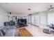 Spacious living room with mirrored wall, shutters on windows and sliding glass doors, wood-look floors at 9021 Feather River Ct, Las Vegas, NV 89117
