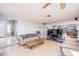 Living room with mirrored wall, wood-look floors, and views into the kitchen and entry at 9021 Feather River Ct, Las Vegas, NV 89117