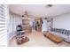 Open living room features a ceiling fan and flows into the kitchen and staircase at 9021 Feather River Ct, Las Vegas, NV 89117