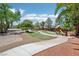 Spacious backyard featuring a walkway, a playground, mature trees, and green lawn for outdoor enjoyment at 9111 W Stephen Ave, Las Vegas, NV 89149