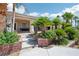 Backyard with lush landscaping, mature palm trees, and a welcoming patio area at 9111 W Stephen Ave, Las Vegas, NV 89149