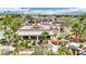 Aerial view of a backyard with palm trees, unique pool with rock features, and covered patio at 9111 W Stephen Ave, Las Vegas, NV 89149