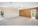 Spacious carpeted bedroom featuring neutral color walls, and a ceiling fan with lighting at 9111 W Stephen Ave, Las Vegas, NV 89149